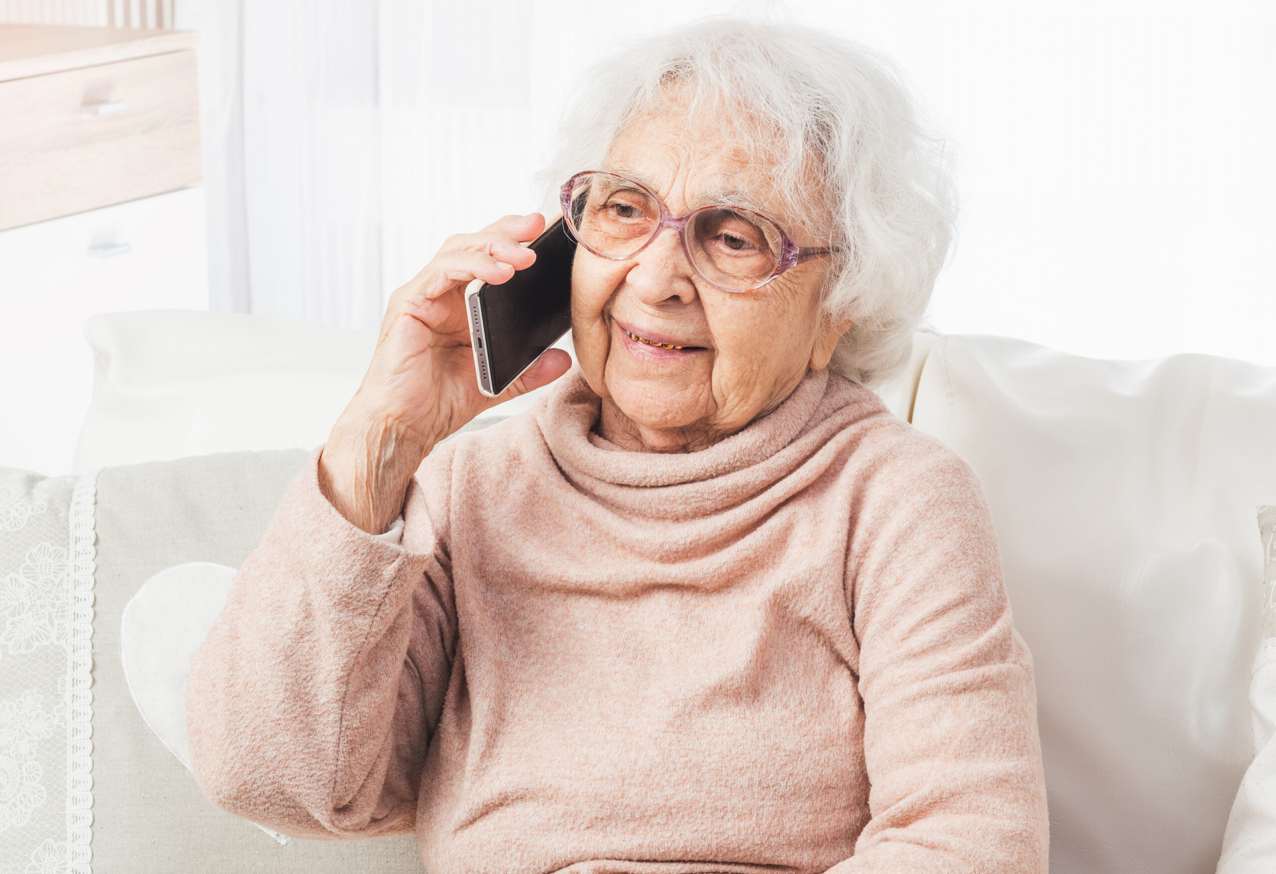 Great-grandmother talking by smartphone